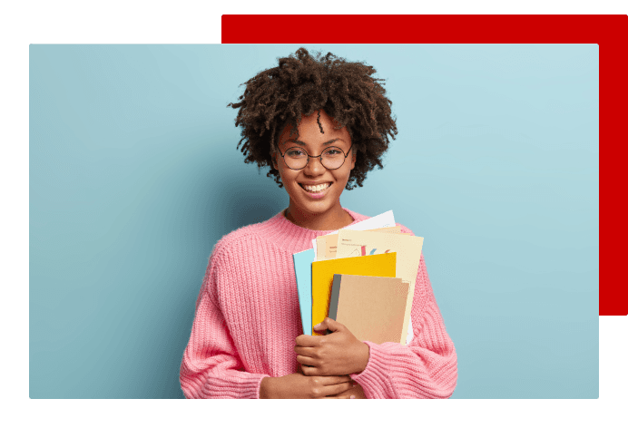 Student smiling and holding books